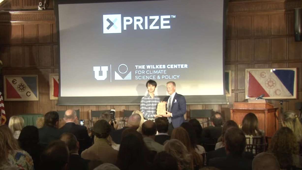Solidec co-founder and CTO Yang Xia, left, accepts the Climate Innovation Prize from Fielding Norton, managing director of the Wilkes Center for Climate Science and Policy. Houston-based Solidec was selected Wednesday as the winner of the $250,000 Wilkes Climate Innovation Prize.