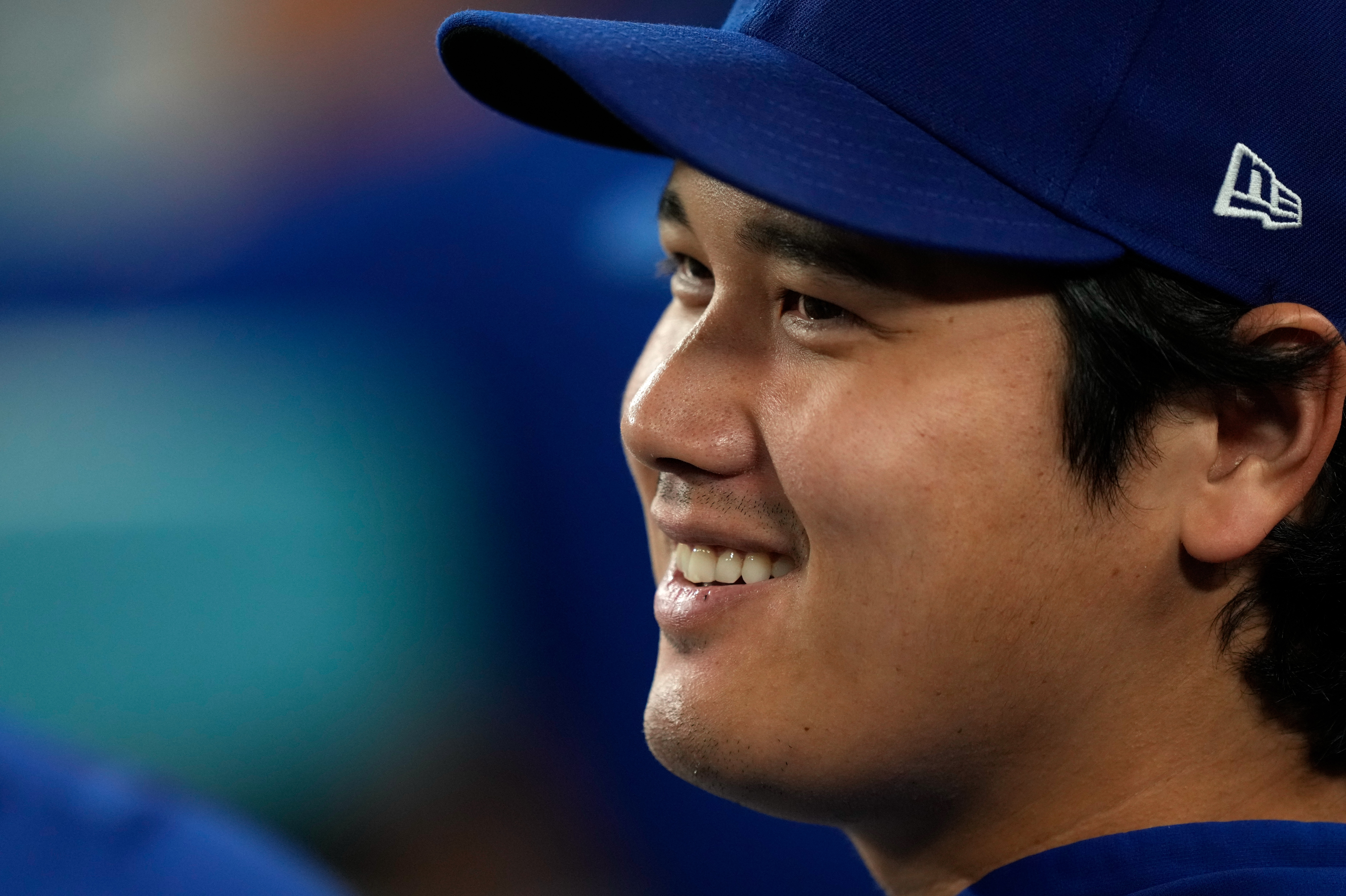 Los Angeles Dodgers' Shohei Ohtani smiles as he sits in the dugout during the eighth inning of a baseball game against the San Diego Padres, Tuesday, Sept. 22, 2026, in Los Angeles. 