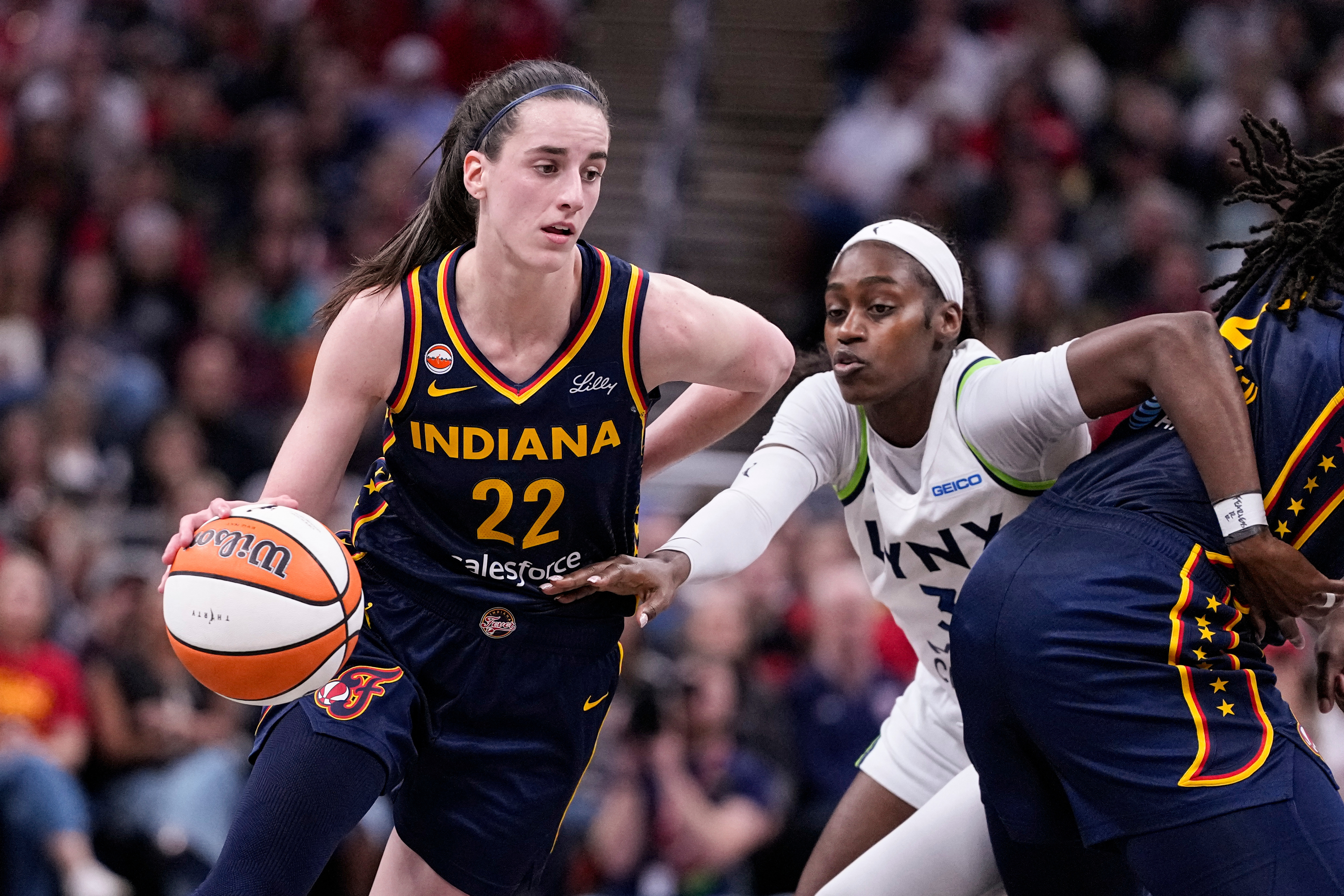 Indiana Fever guard Caitlin Clark (22) drives past Minnesota Lynx guard Maya Caldwell (3) in the second half of a WNBA basketball game in Indianapolis, Tuesday, Sept. 22, 2026. 