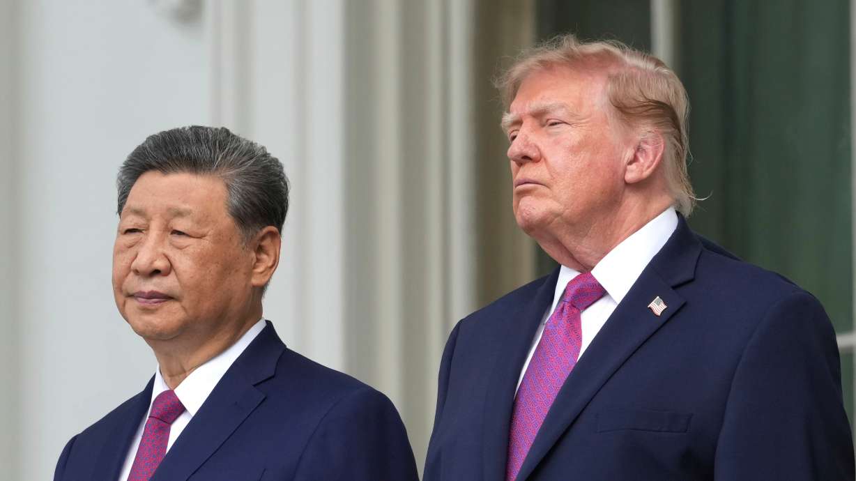 President Donald Trump and China's President Xi Jinping watch a silent drill platoon review on the new helipad from the Blue Room Balcony of the White House, Thursday, in Washington. The summit between Trump and Xi is expected to be heavy on symbolism but light on substance.