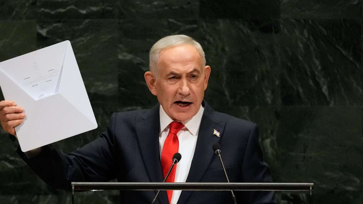 Israeli Prime Minister Benjamin Netanyahu holds up a Starlink satellite internet dish as he speaks during the 81st session of the United Nations General Assembly at United Nations headquarters, Thursday. Netanyahu mounted a forceful defense of his nation's actions as dozens of delegates walked out in protest.