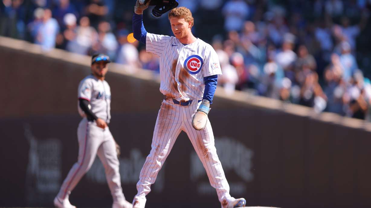 Chicago Cubs' Pete Crow-Armstrong raises his helmet to the crowd after stealing second base for his 40th steal of the season during the first inning of a baseball game against the Miami Marlins, Thursday , Sept. 24, 2026, in Chicago.