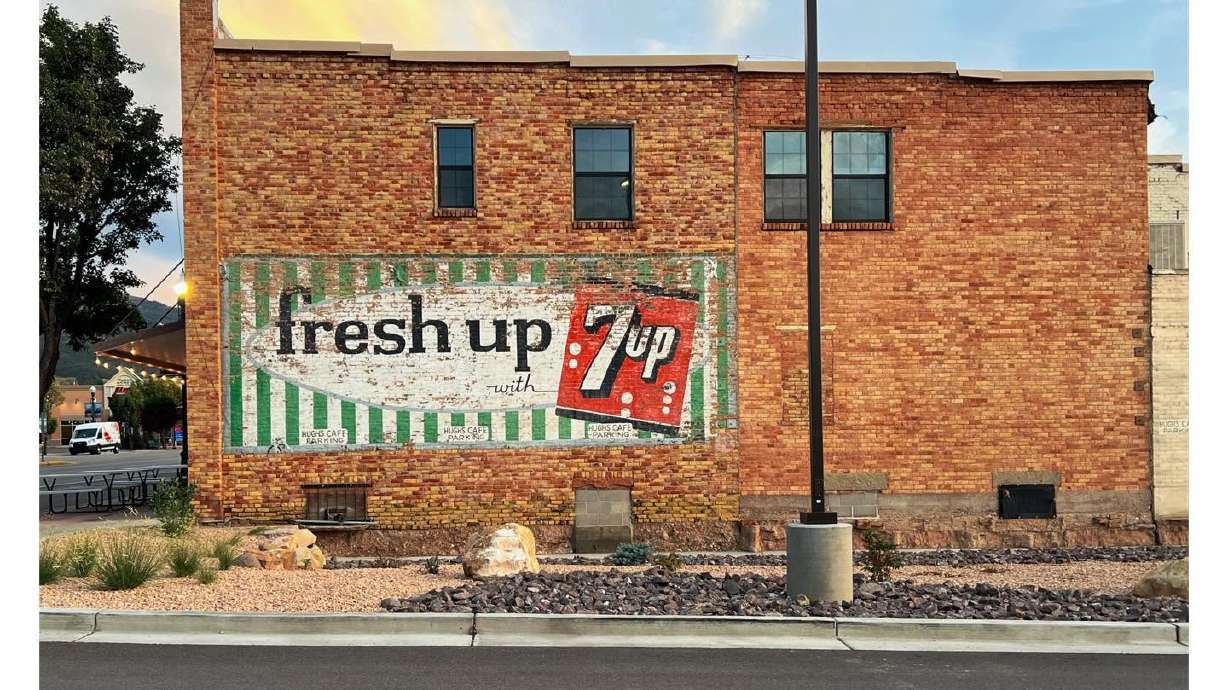 Gloria and Richard Gratton were engaged in 1974 in front of a historic 7UP sign that has recently been uncovered on Main Street in Cedar City.