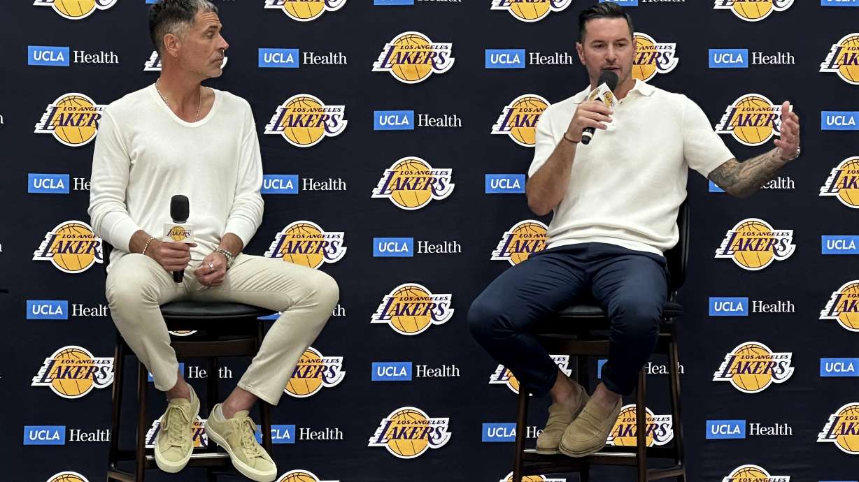 Los Angeles Lakers general manager Rob Pelinka, left and head coach JJ Redick speak with reporters in a news conference at the Lakers' training complex in El Segundo, Calif., on Thursday, Sept. 24, 2026.