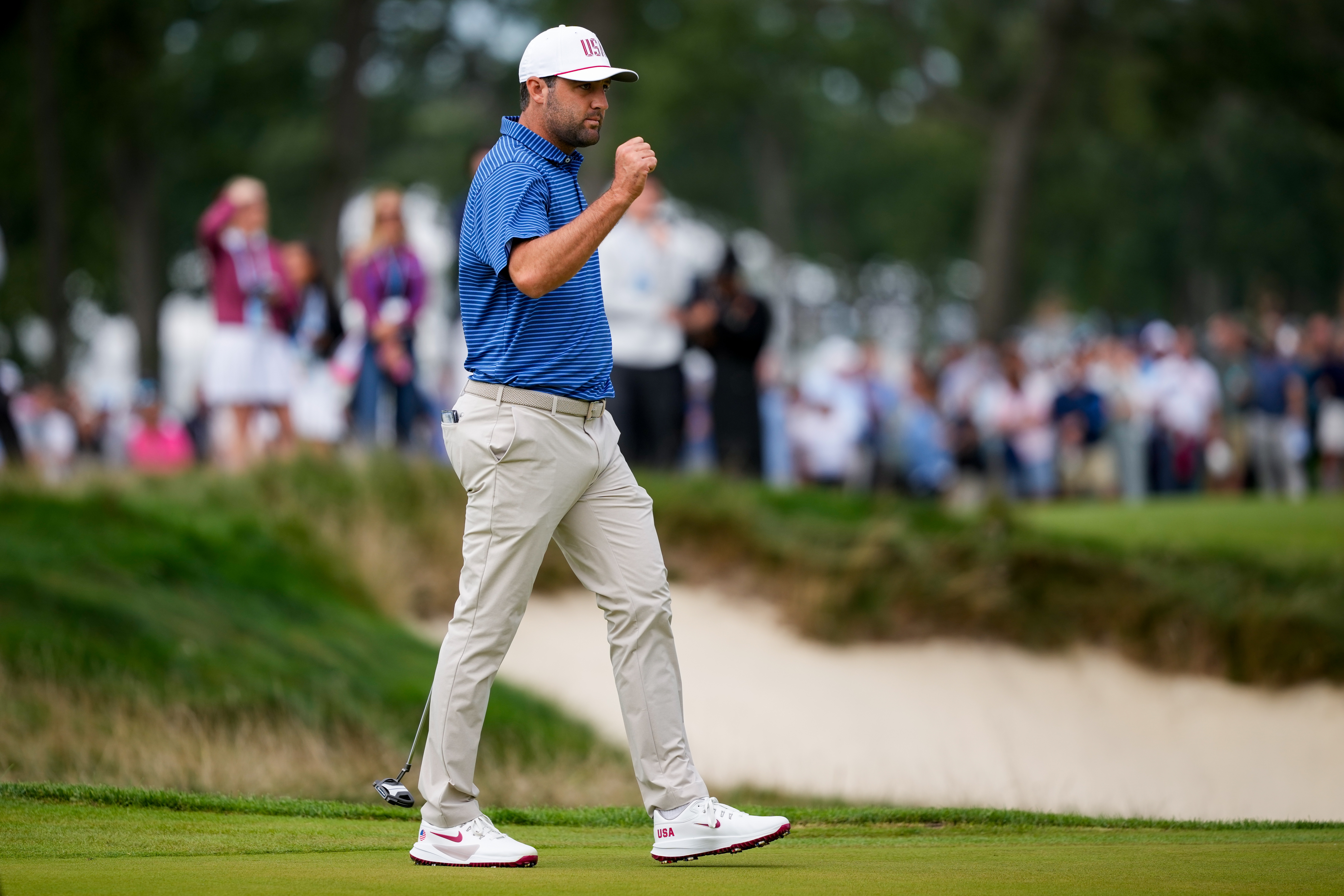 USA teams' Scottie Scheffler reacts to making his birdie putt on the first hole against the International teams during the first round four-ball match at the Presidents Cup golf tournament at Medinah Country Club, Thursday, Sept. 24, 2026, in Medinah, Ill. 
