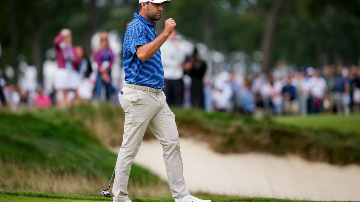 USA teams' Scottie Scheffler reacts to making his birdie putt on the first hole against the International teams during the first round four-ball match at the Presidents Cup golf tournament at Medinah Country Club, Thursday, Sept. 24, 2026, in Medinah, Ill.
