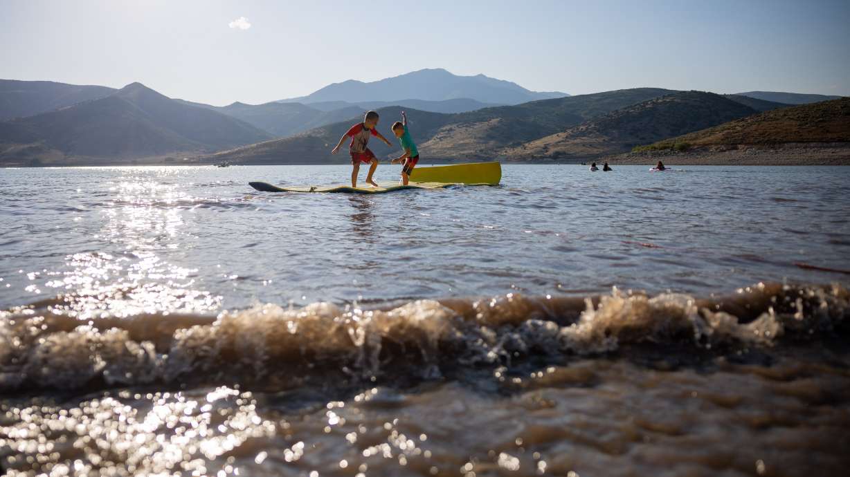 Emit Provost, 6, and George Barber, 6, play in Deer Creek Reservoir in Wasatch County on July 30. A new Pew Research report found cyberattacks targeting water systems are rising.