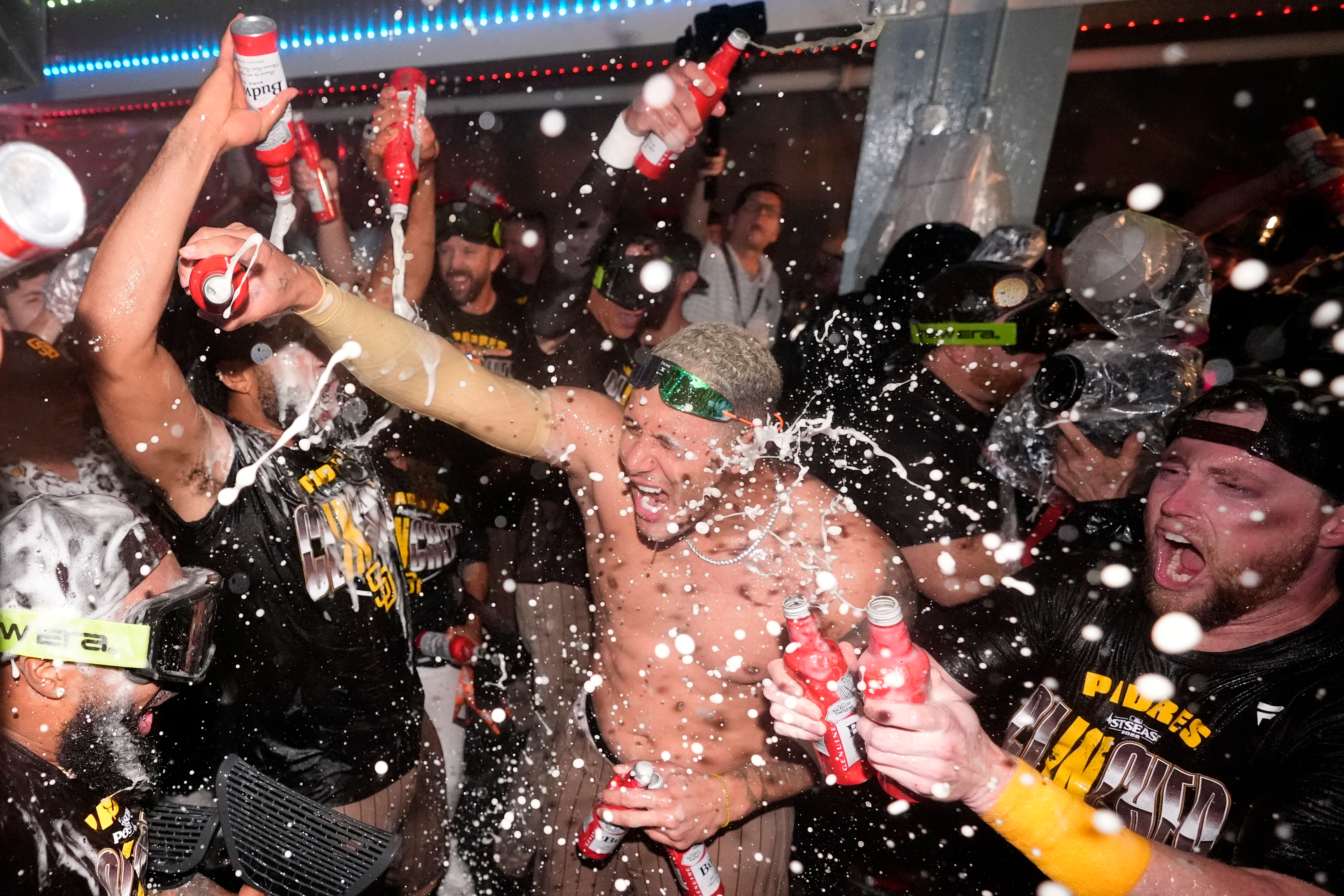 San Diego Padres' Manny Machado, center, celebrates with teammates after the Padres clinched a wildcard spot following a baseball game against the Los Angeles Dodgers, Thursday, Sept. 24, 2026, in Los Angeles. 