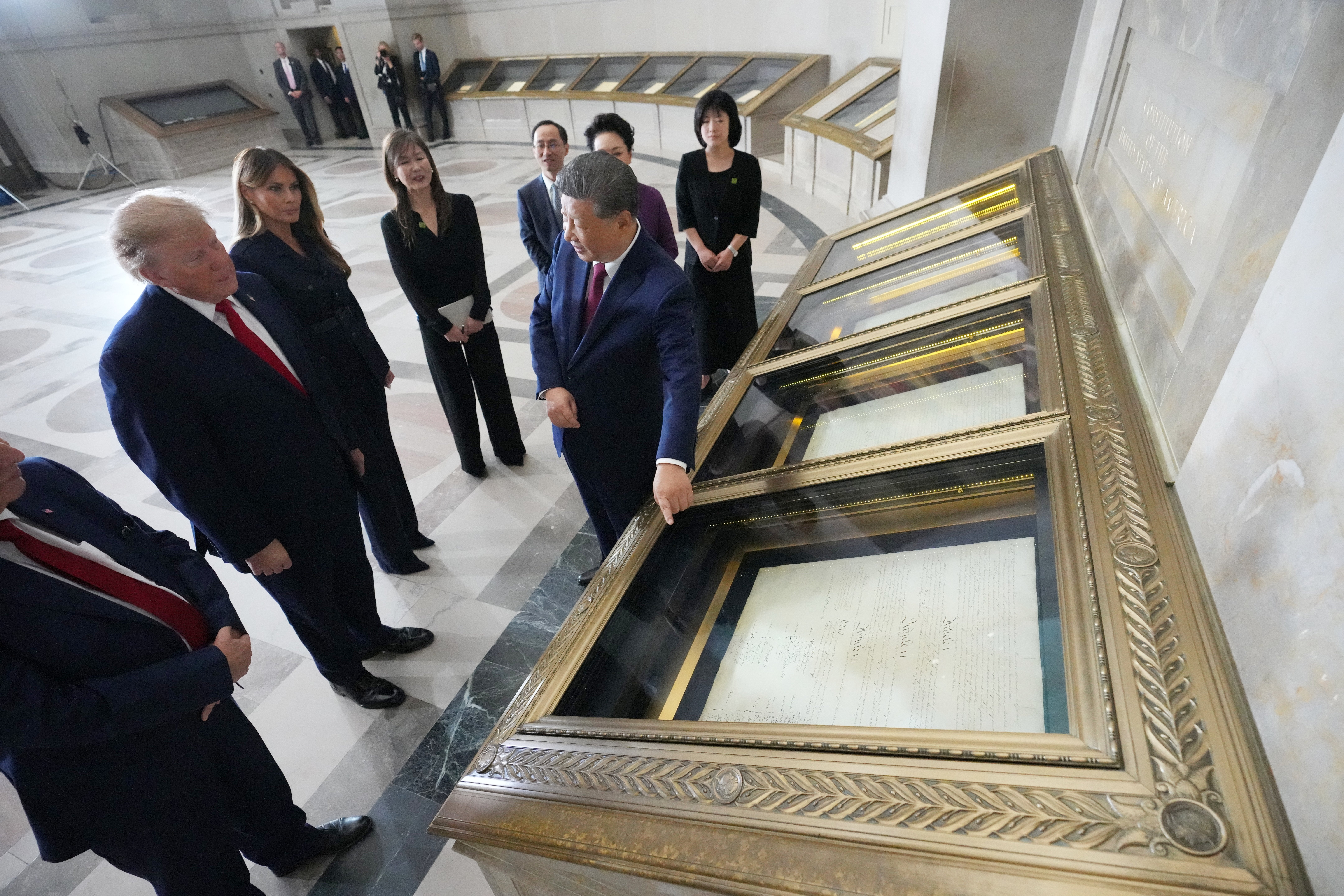 President Donald Trump, first lady Melania Trump, China's President Xi Jinping and his wife Peng Liyuan, with Bradford Wilson, Archivist of the United States, view the Constitution, Bill of Rights and other documents at the National Archives, Friday, in Washington. The two leaders compared the history of their two nations during the visit.