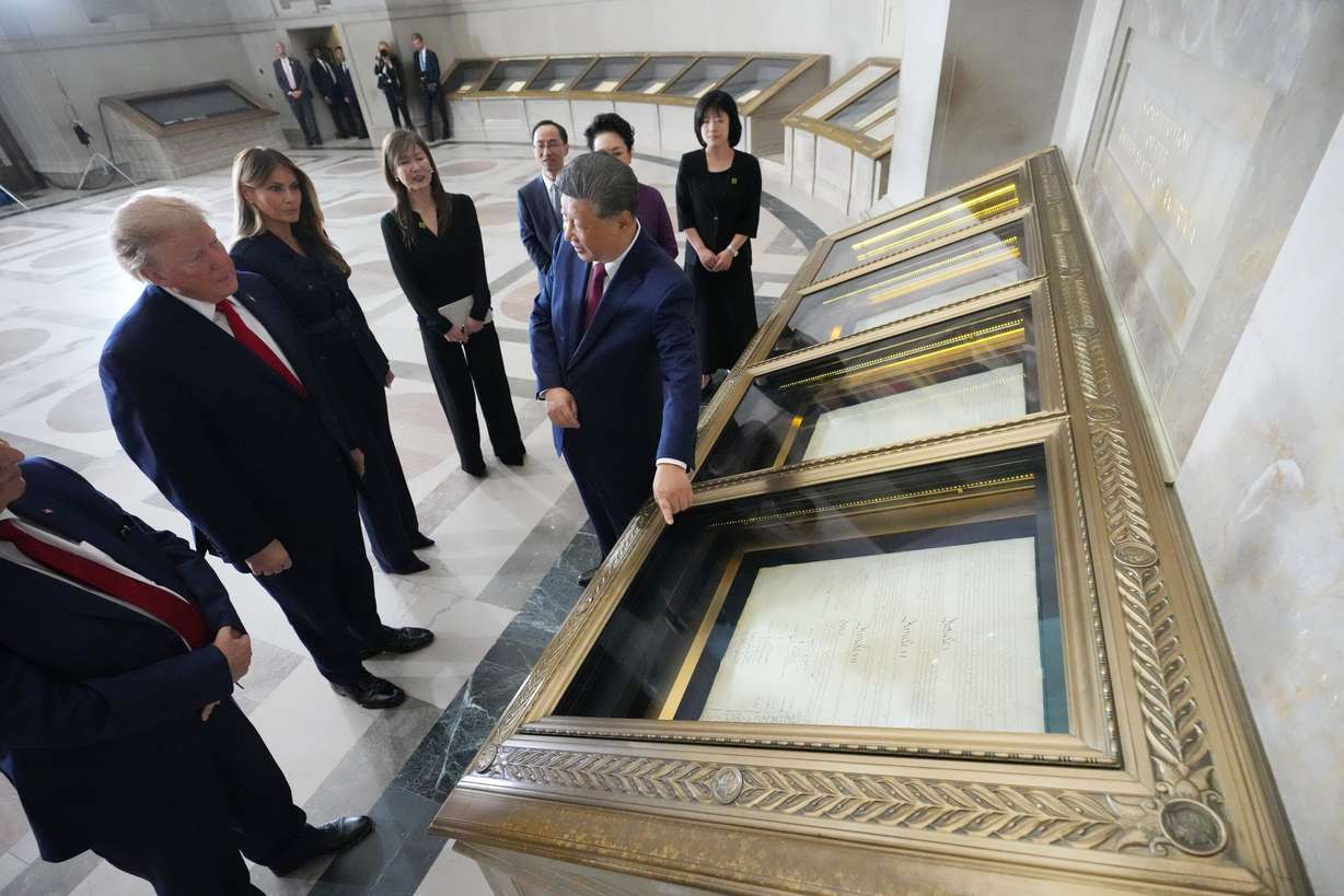 President Donald Trump, first lady Melania Trump, China's President Xi Jinping and his wife Peng Liyuan, with Bradford Wilson, Archivist of the United States, view the Constitution, Bill of Rights and other documents at the National Archives, Friday, in Washington. The two leaders compared the history of their two nations during the visit.