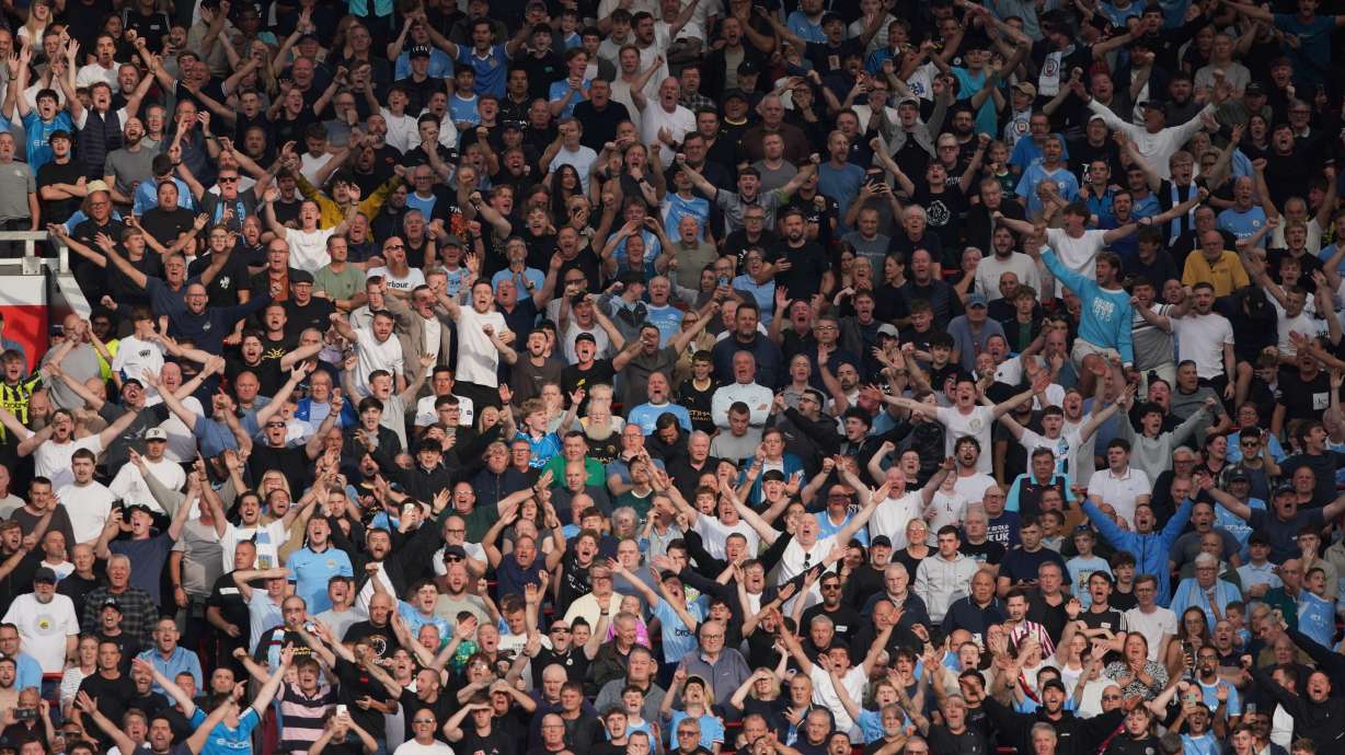 Man City fans cheer during the English Premier League soccer match between Manchester United and Manchester City in Manchester, England, Sunday, Sept. 13, 2026.