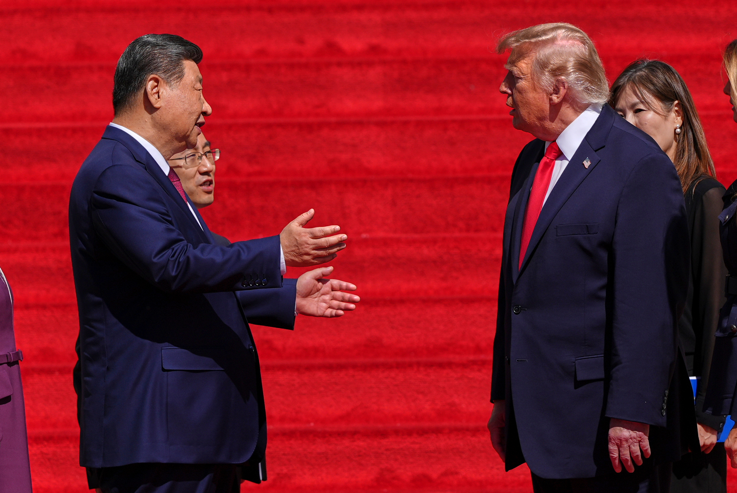 China's President Xi Jinping speaks with President Donald Trump on the steps of the National Archives Museum, Friday, in Washington. The leaders discussed the Iran war and other topics behind closed doors on Thursday.