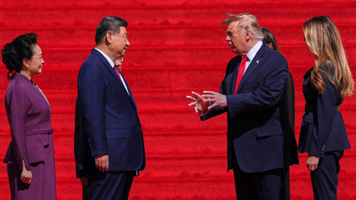 President Donald Trump and first lady Melania Trump speak with China's President Xi Jinping and his wife Peng Liyuan on the steps of the National Archives Museum, Friday, in Washington. Xi wrapped up his trip to the U.S. by saying he would see Trump again soon, which Trump confirmed.