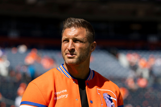 Tim Tebow looks on prior to an NFL football game against the Jacksonville Jaguars, Sunday, Sept. 20, 2026 in Denver. 
