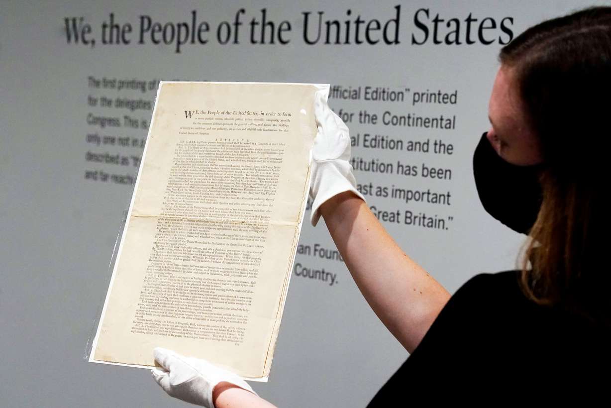 Ella Hall, a specialist in Books and Manuscripts at Sotheby's, in New York, holds a 1787 printed copy of the U.S. Constitution, Sept. 17, 2021. Utahns largely agree with President Dallin H. Oaks' recent call for political compromise, according to a new poll.
