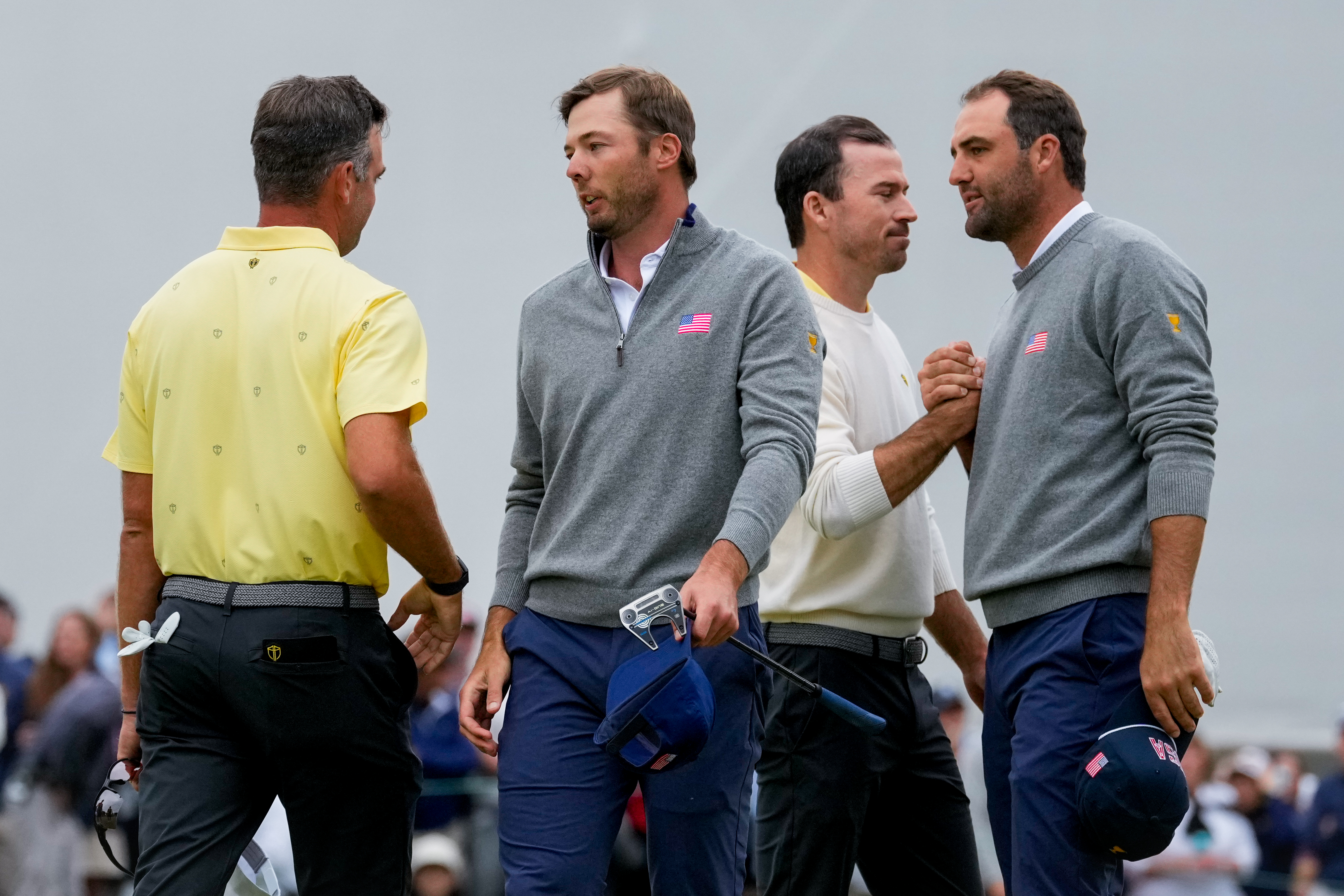 USA teams' Scottie Scheffler, right, and Sam Burns greet International teams' Corey Conners, of Canada, left, and Nick Taylor, of Canada, after their Presidents Cup golf tournament second round foursomes match at Medinah Country Club, Friday, Sept. 25, 2026, in Medinah, Ill. 