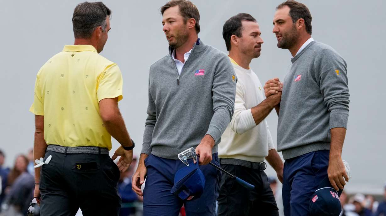 USA teams' Scottie Scheffler, right, and Sam Burns greet International teams' Corey Conners, of Canada, left, and Nick Taylor, of Canada, after their Presidents Cup golf tournament second round foursomes match at Medinah Country Club, Friday, Sept. 25, 2026, in Medinah, Ill.
