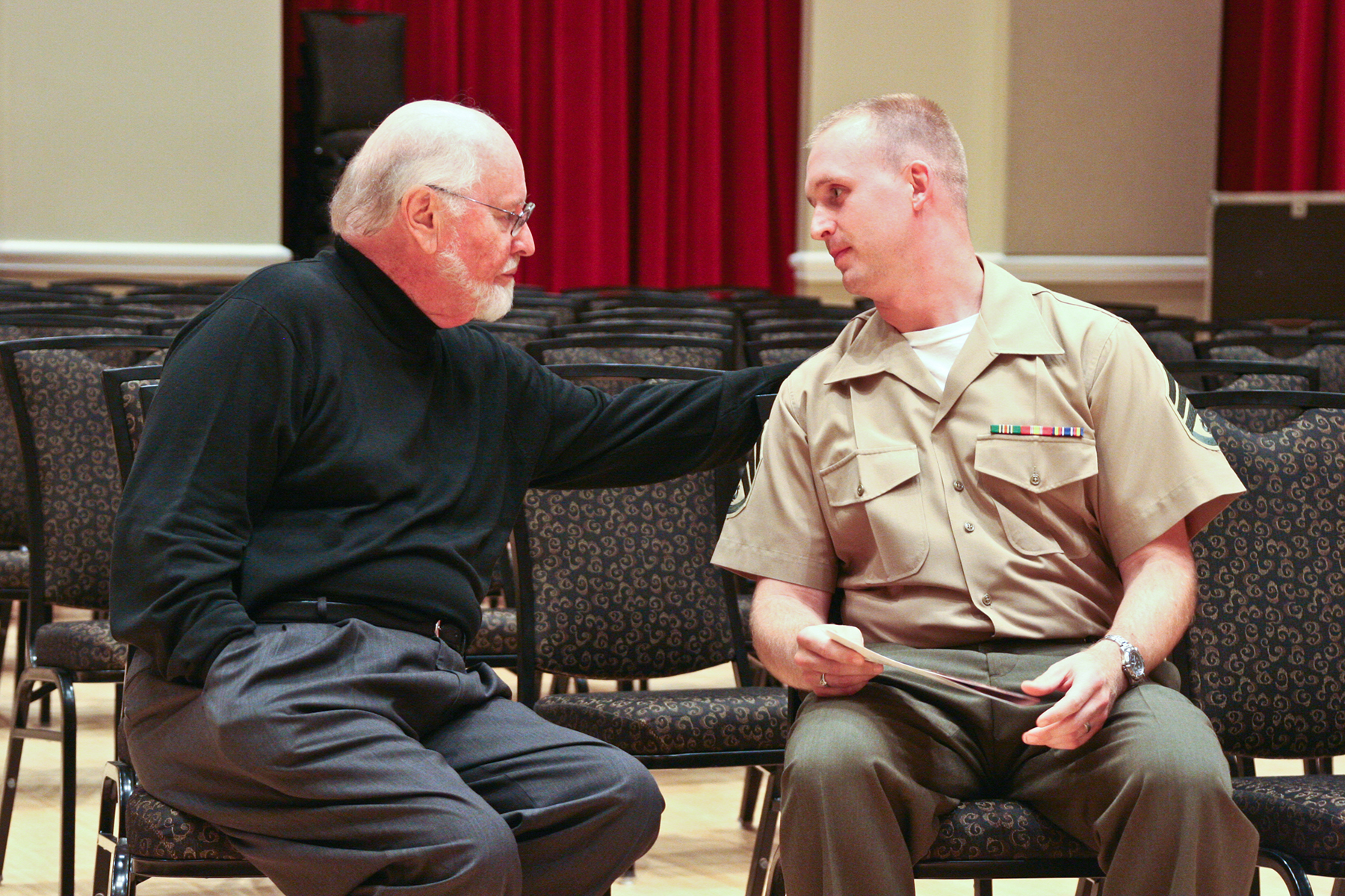 Master Sgt. Brian Rust meets with composer John Williams in 2008 when Williams guest conducted the Marine Band for its 210th anniversary.