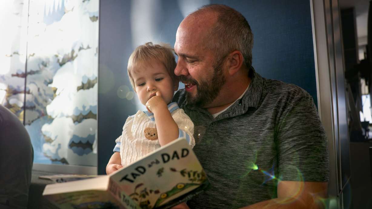 Two-year-old Tillman Davies and his father, Andrew, read a book together on Dolly Parton Day at Glacier Hills Elementary School, Friday, in Sandy. The Dolly Parton Imagination Library is partnering with the Canyons Education Foundation to provide free books to every preschool child living in the Canyons boundaries.