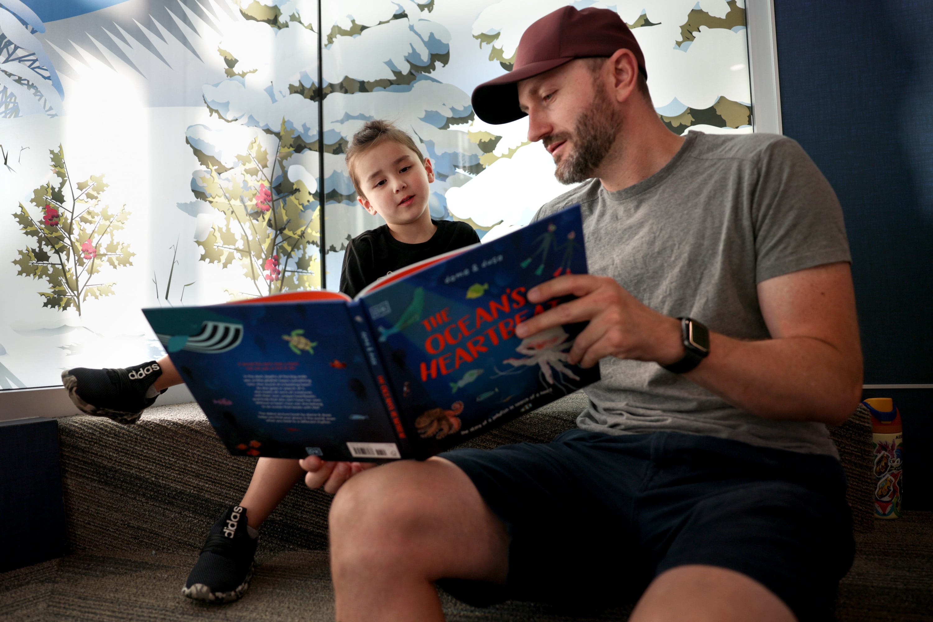 Four-year-old Aiden Robertson and his father, Anthony, read a book together on Dolly Parton Day at Glacier Hills Elementary School, Friday, in Sandy. The Dolly Parton Imagination Library is partnering with the Canyons Education Foundation to provide free books to every preschool child living in the Canyons boundaries.