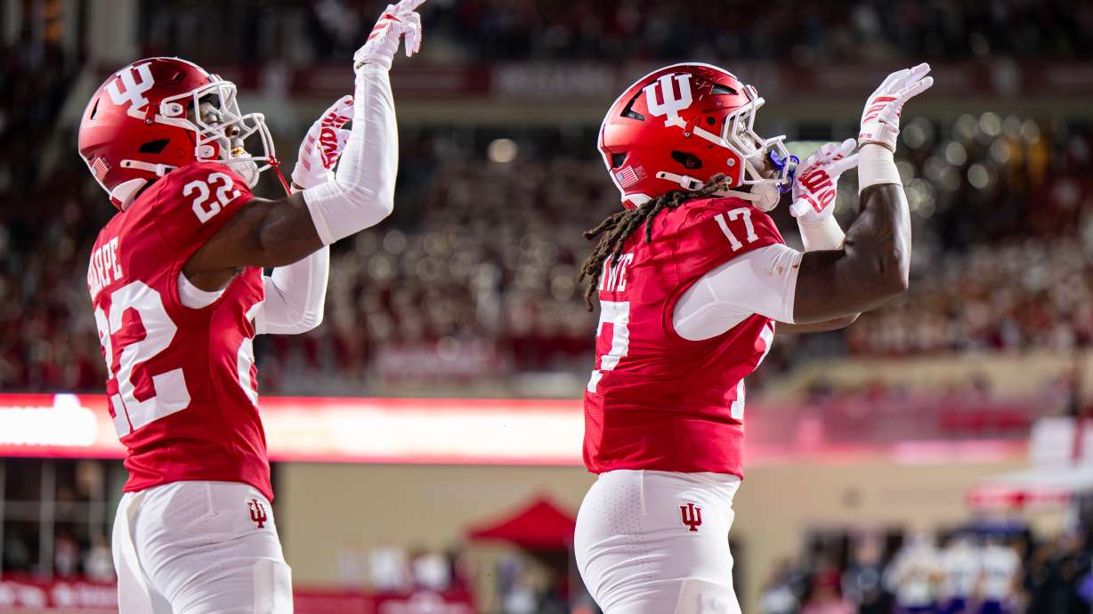 Indiana defensive back Jamari Sharpe (22) and defensive lineman Daniel Ndukwe (17) react after scoring a safety against Northwestern during the first half of an NCAA college football game, Friday, Sept. 25, 2026, in Bloomington, Ind.