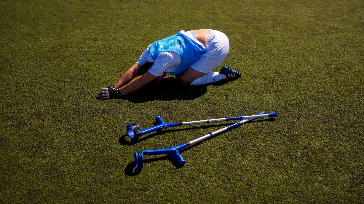 Panathinaikos' Vasileios Gogolos stretches during an amputee soccer match between Maccabi Haifa and Panathinaikos in the inaugural EAFF Conference League in Bucharest, Romania, Thursday, Sept. 24, 2026.