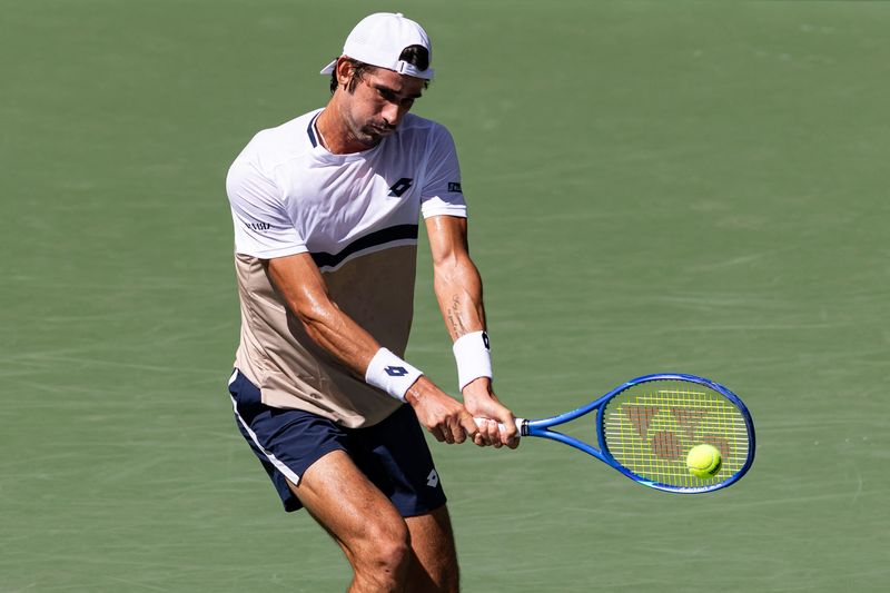 Aug 27, 2025; Flushing, NY, USA; Lloyd Harris of South Africa in action against Taylor Fritz of the United States in the second round of the men’s singles at the US Open at Louis Armstrong Stadium in Billie Jean King National Tennis Center.