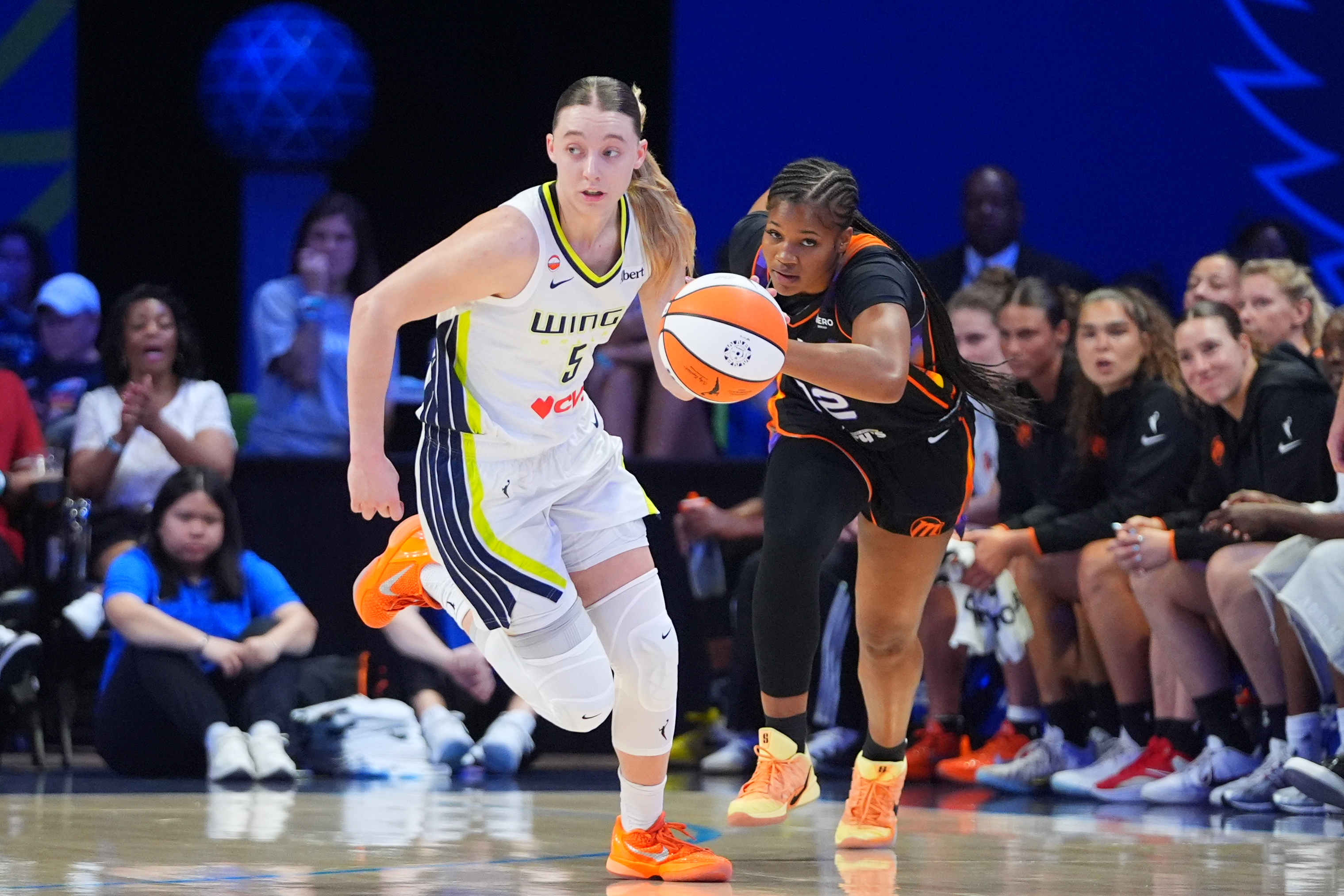 Dallas Wings guard Paige Bueckers (5) comes up with ball against Phoenix Mercury guard Kara Dunn (12) during the first half of a WNBA basketball game in Arlington, Texas, Saturday, Sept. 19, 2026. 