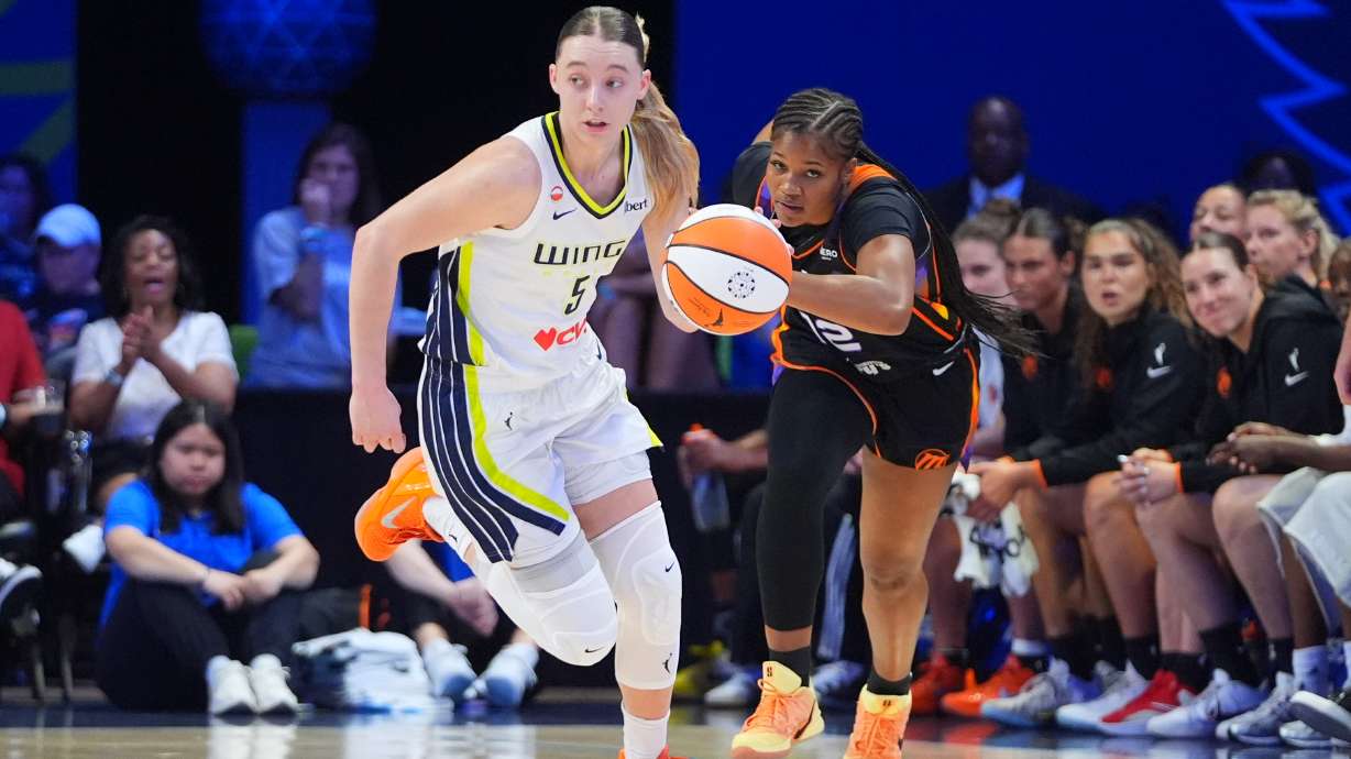 Dallas Wings guard Paige Bueckers (5) comes up with ball against Phoenix Mercury guard Kara Dunn (12) during the first half of a WNBA basketball game in Arlington, Texas, Saturday, Sept. 19, 2026.