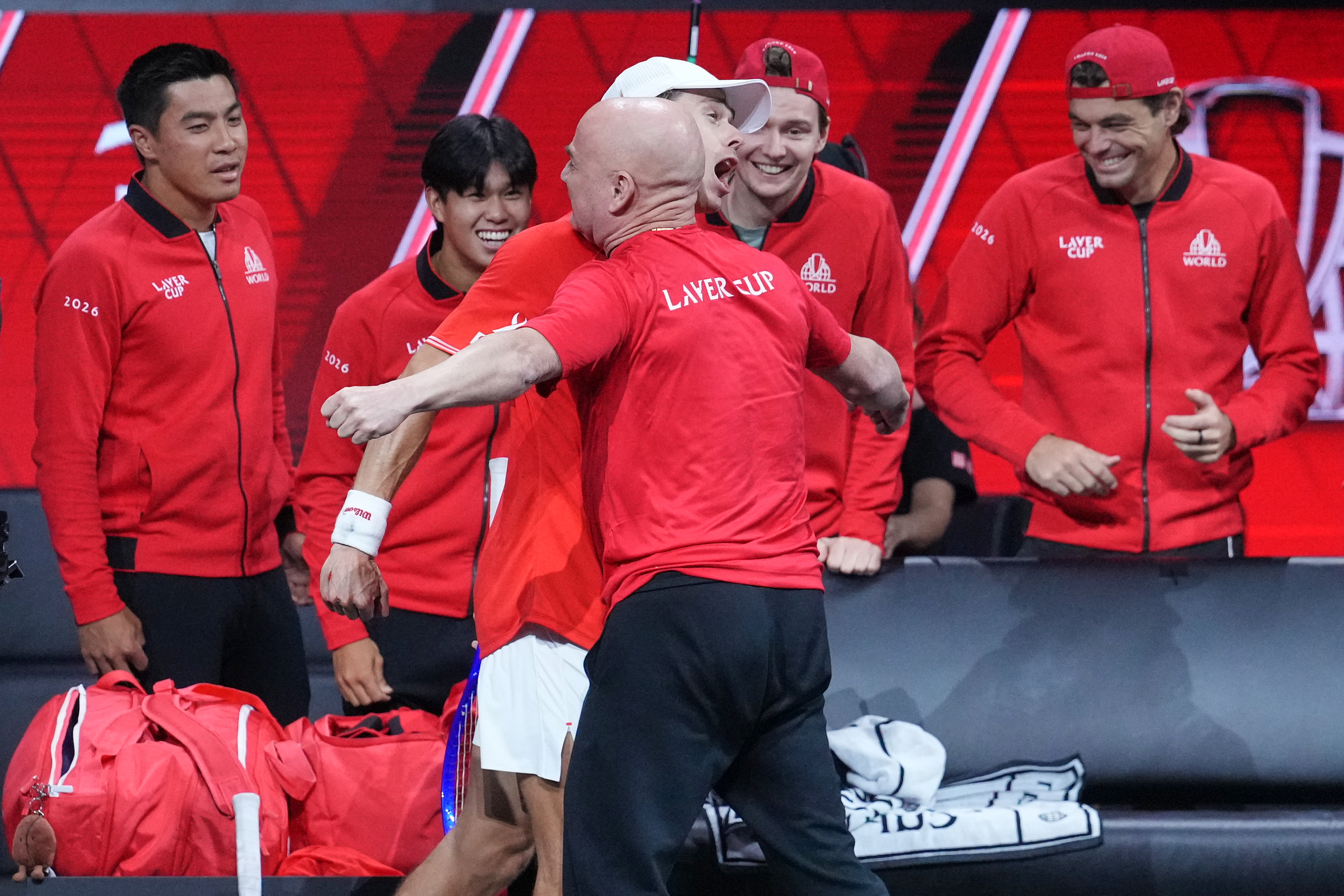 Team World's Alex De Minaur celebrates with Team World captain Andre Agassi after beating Team Europe's Alexander Zverev in a Laver Cup tennis tournament match in London, Saturday, Sept. 26, 2026. 