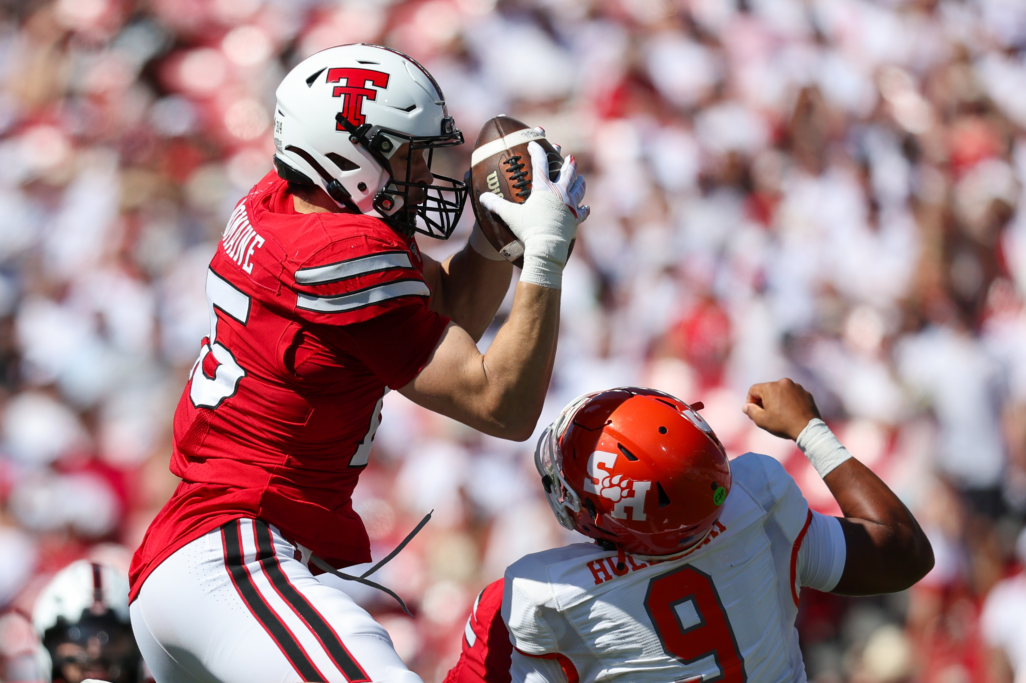 Texas Tech linebacker Austin Romaine (15) intercepts pass over Sam Houston State's Brett Holloway during the first half of an NCAA college football game, Saturday, Sept. 26, 2026, in Lubbock, Texas. 