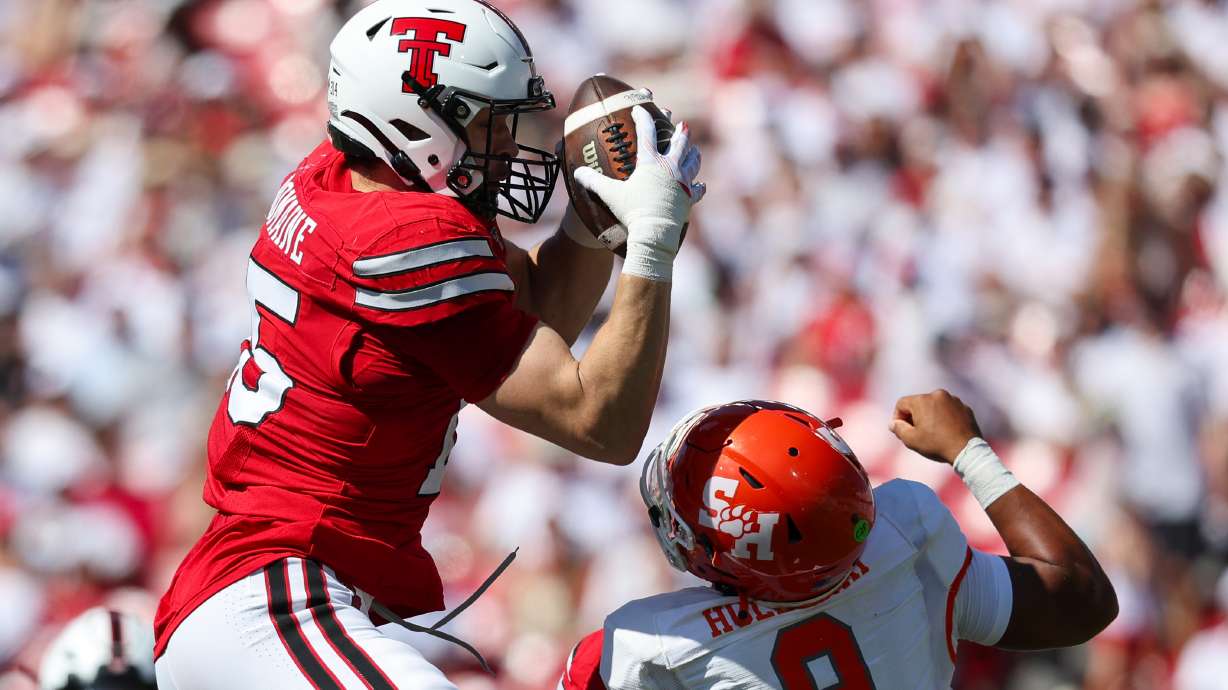 Texas Tech linebacker Austin Romaine (15) intercepts pass over Sam Houston State's Brett Holloway during the first half of an NCAA college football game, Saturday, Sept. 26, 2026, in Lubbock, Texas.