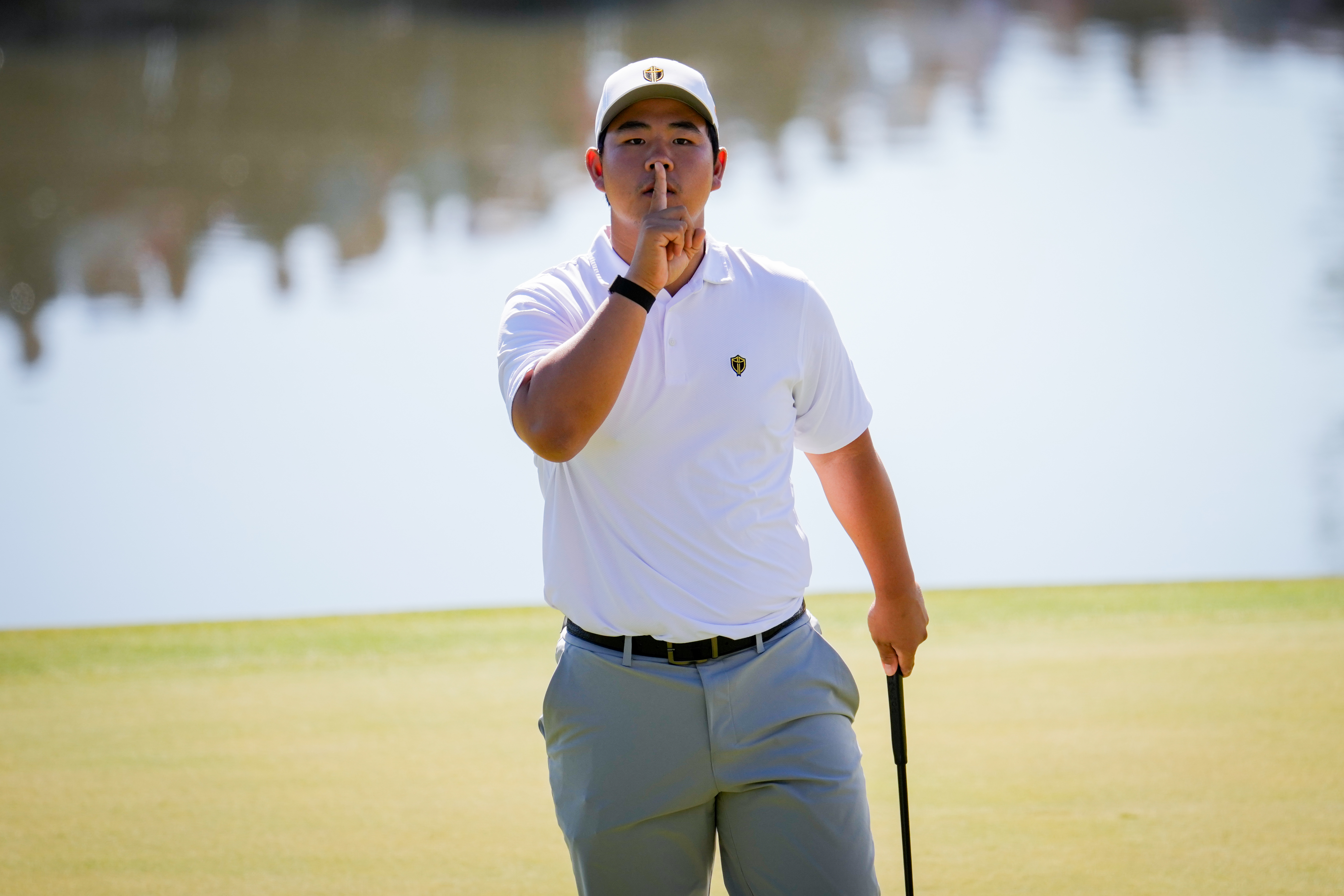 International teams' Tom Kim, of South Korea, reacts after his shot on the 12th green against the USA team during a Presidents Cup golf tournament third round four-ball match at Medinah Country Club, Saturday, Sept. 26, 2026, in Medinah, Ill. 
