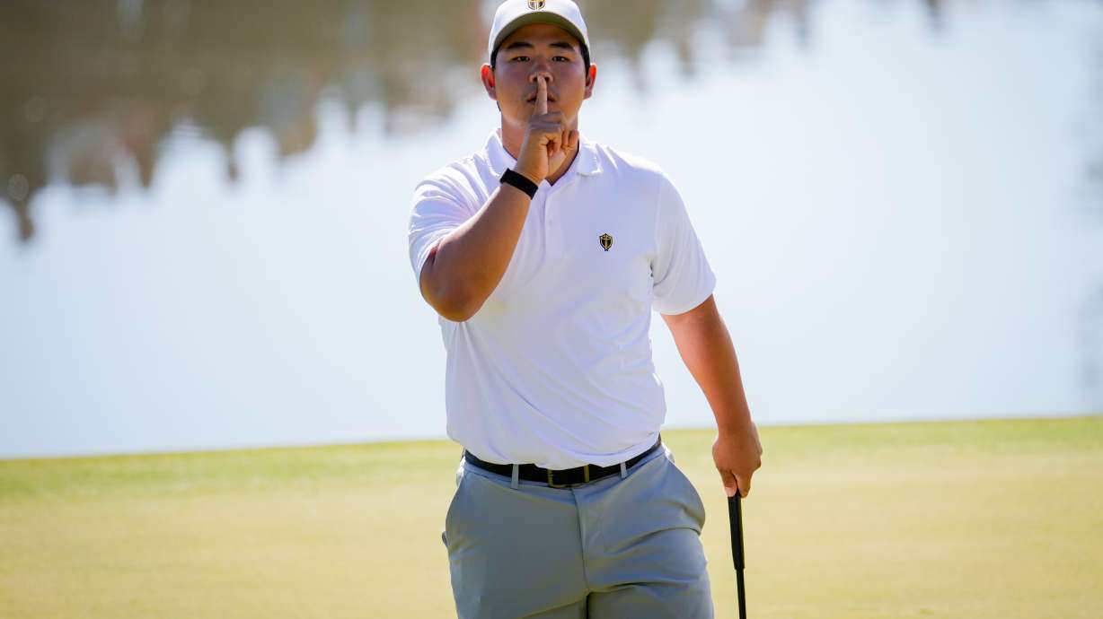 International teams' Tom Kim, of South Korea, reacts after his shot on the 12th green against the USA team during a Presidents Cup golf tournament third round four-ball match at Medinah Country Club, Saturday, Sept. 26, 2026, in Medinah, Ill.