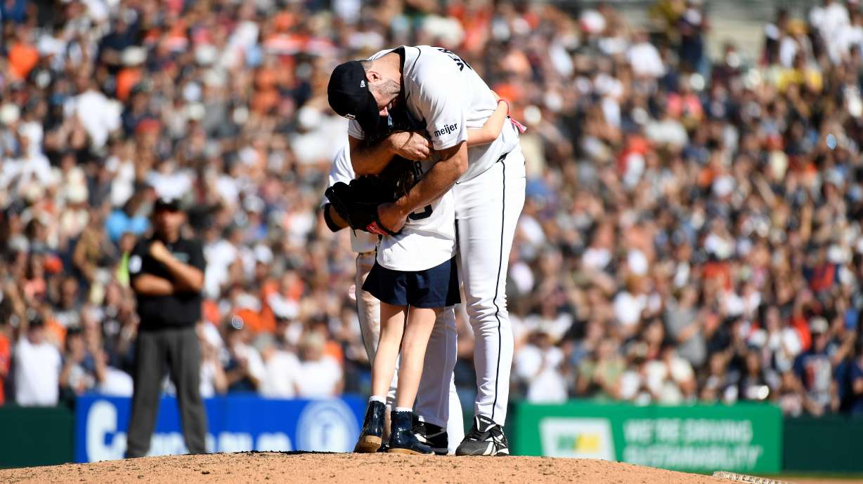 Genevieve Verlander, left, hugs her dad, Detroit Tigers starting pitcher Justin Verlander, during the sixth inning of a baseball game against the Pittsburgh Pirates, Saturday, Sept. 26, 2026, in Detroit.