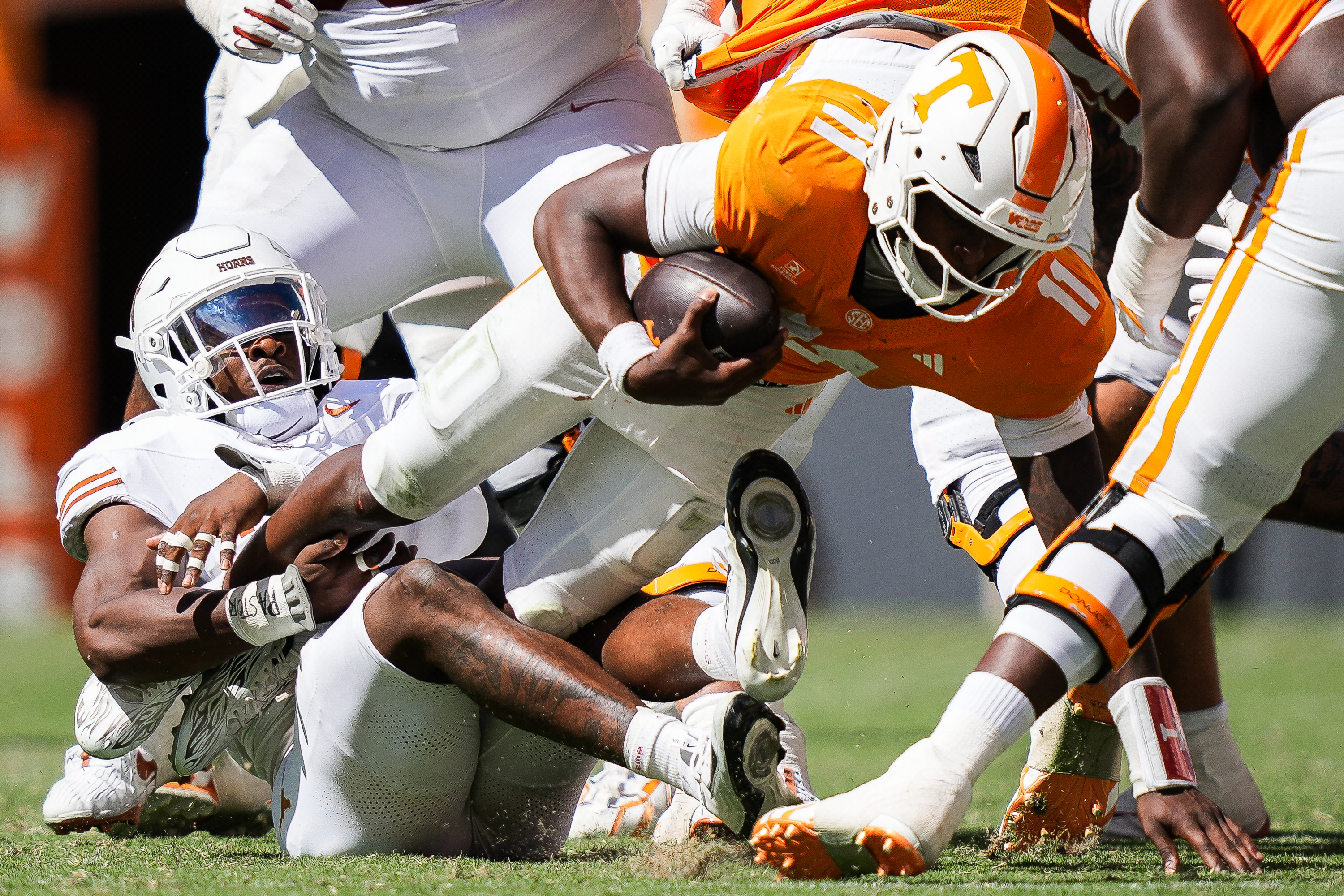 Texas defensive end Colin Simmons (1) brings down Tennessee quarterback Faizon Brandon (11) during the second half of an NCAA college football game in Knoxville, Tenn., Saturday, Sept. 26, 2026. 