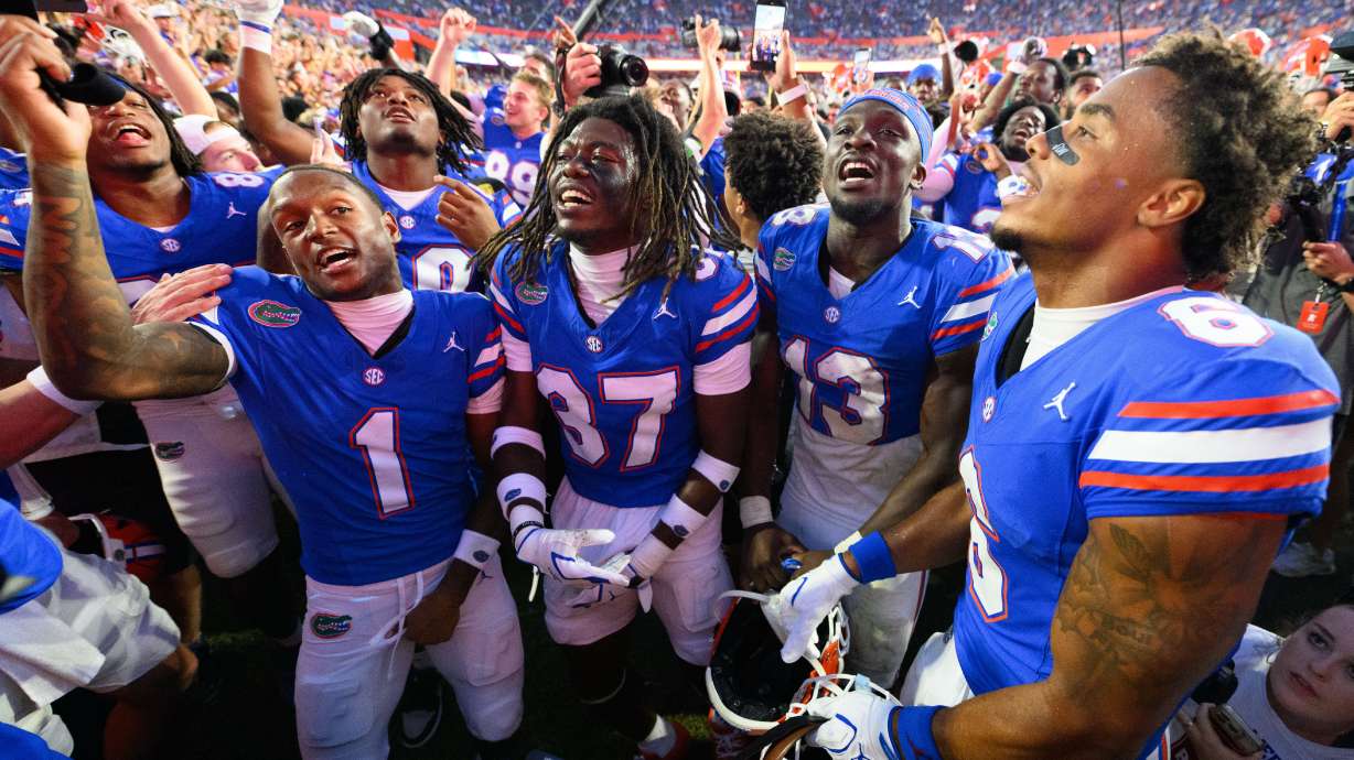 Florida wide receiver Vernell Brown III (1), cornerback Javion Toombs (37), running back Jadan Baugh (13) and wide receiver Dallas Wilson (6) celebrate after winning an NCAA college football game against Mississippi, Saturday, Sept. 26, 2026, in Gainesville, Fla.