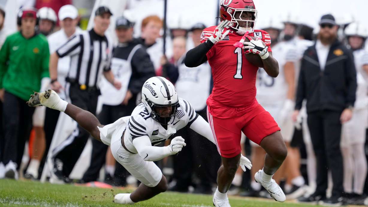 Utah running back Wayshawn Parker (1) breaks a tackle by Iowa State safety Duhron Goodman (21) during a touchdown run in the first half of an NCAA college football game, Saturday, Sept. 26, 2026, in Ames, Iowa.