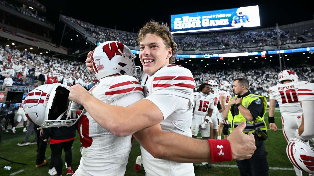 Wisconsin's Sean West, right, celebrates with James Roe, left, after their team defeated Penn State in an NCAA college football game, Saturday, Sept. 26, 2026, in State College, Pa.