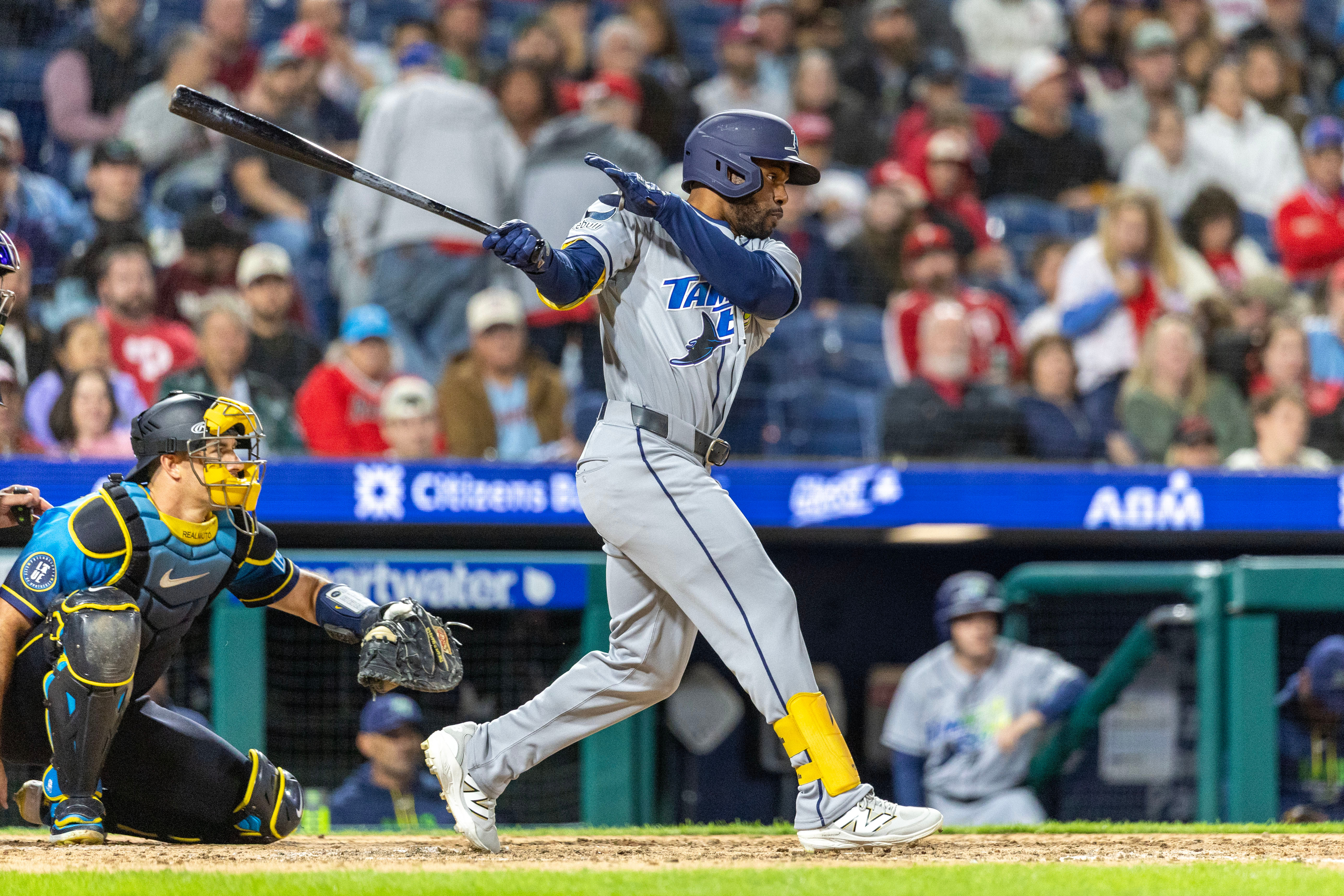 Tampa Bay Rays' Cedric Mullins, right, follows through on a single during the ninth inning of a baseball game against the Philadelphia Phillies, Friday, Sept. 25, 2026, in Philadelphia. 
