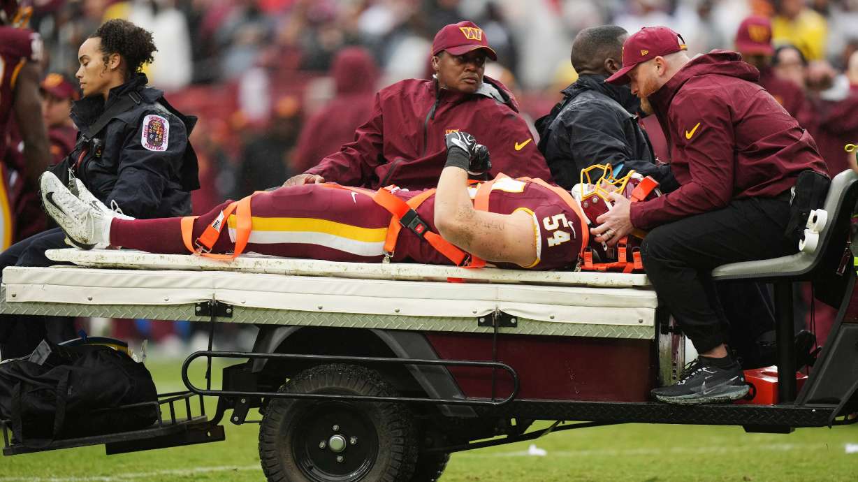 Washington Commanders linebacker Leo Chenal (54) is transported off the field by the medical team during the first half of an NFL football game against the Seattle Seahawks, Sunday, Sept. 27, 2026 in Landover, Md.