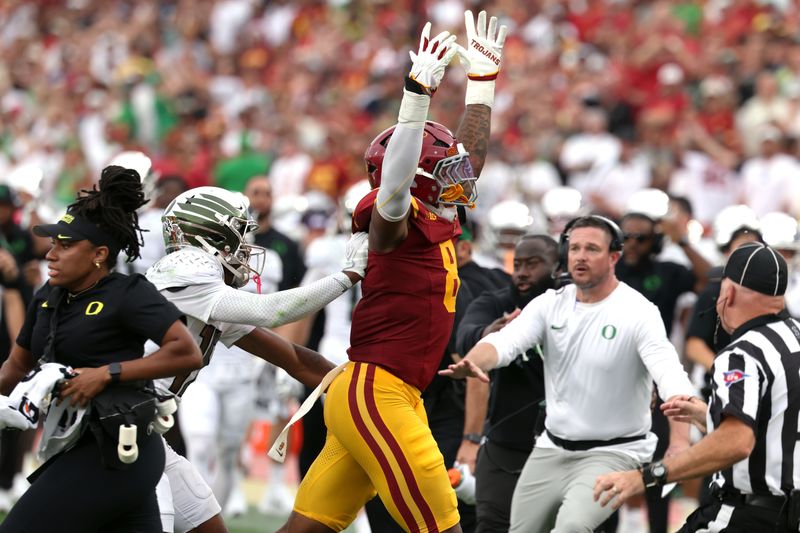 Sep 26, 2026; Los Angeles, California, USA;  USC Trojans linebacker Desman Stephens II (8) reacts after tackling Oregon Ducks quarterback Dante Moore (not pictured) before he is charged with targeting during the second quarter at United Airlines Field at Los Angeles Memorial Coliseum.