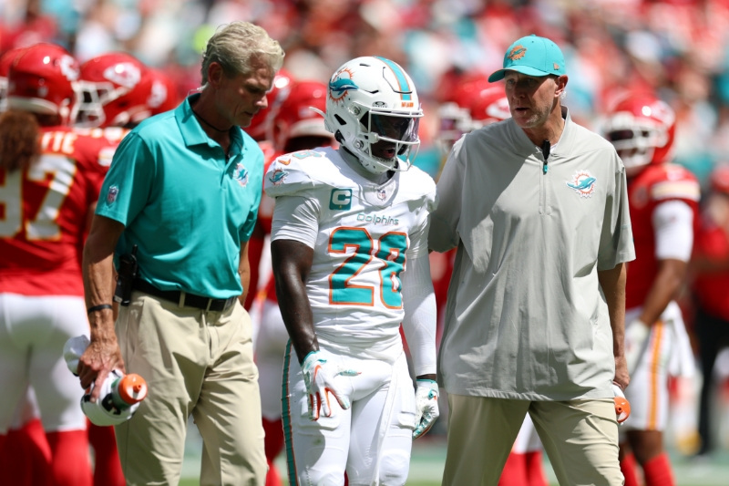 Sep 27, 2026; Miami Gardens, Florida, USA;  Miami Dolphins running back De'Von Achane (28) is walked off the field during the first quarter against the Kansas City Chiefs at Hard Rock Stadium.