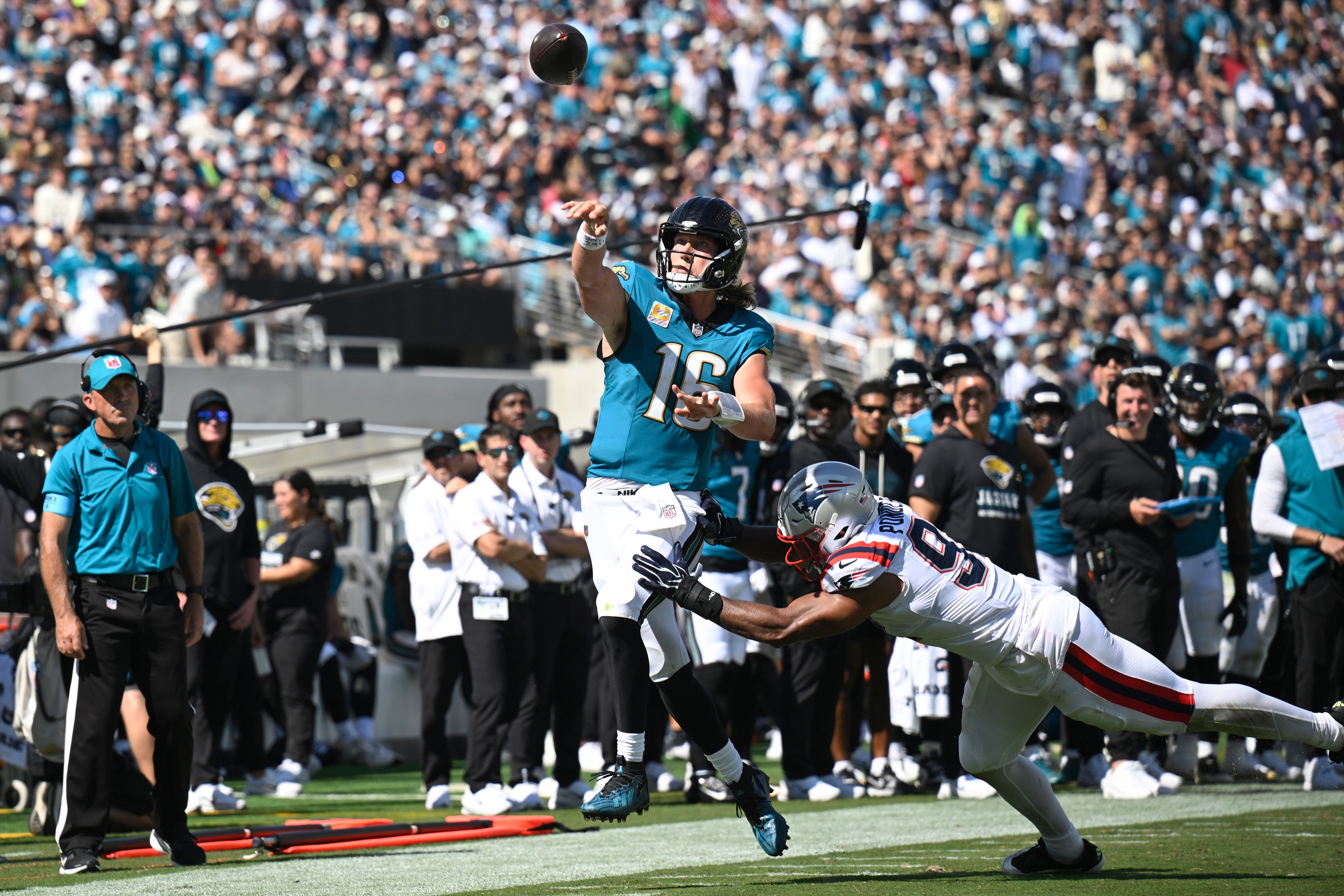 Jacksonville Jaguars quarterback Trevor Lawrence (16) passes against New England Patriots linebacker Elijah Ponder (91) in the second half during an NFL football game in Jacksonville, Fla., Sunday, Sept. 27, 2026. 