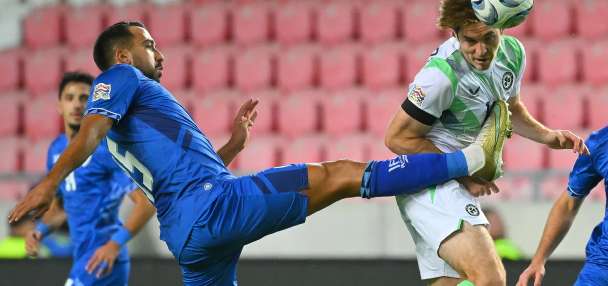 Ireland players wear black armbands and refrain from handshakes in soccer game against Israel
