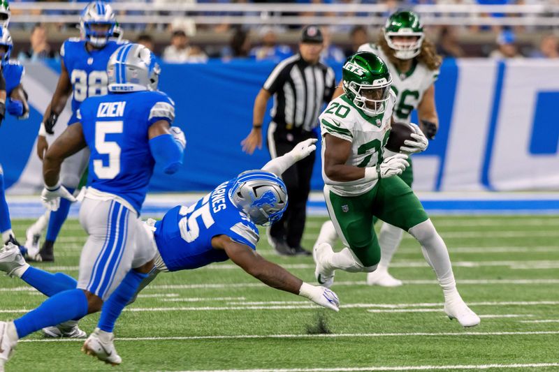 Sep 27, 2026; Detroit, Michigan, USA;  New York Jets running back Breece Hall (20) eludes a tackle by Detroit Lions linebacker Derrick Barnes (55) during the second quarter at Ford Field.