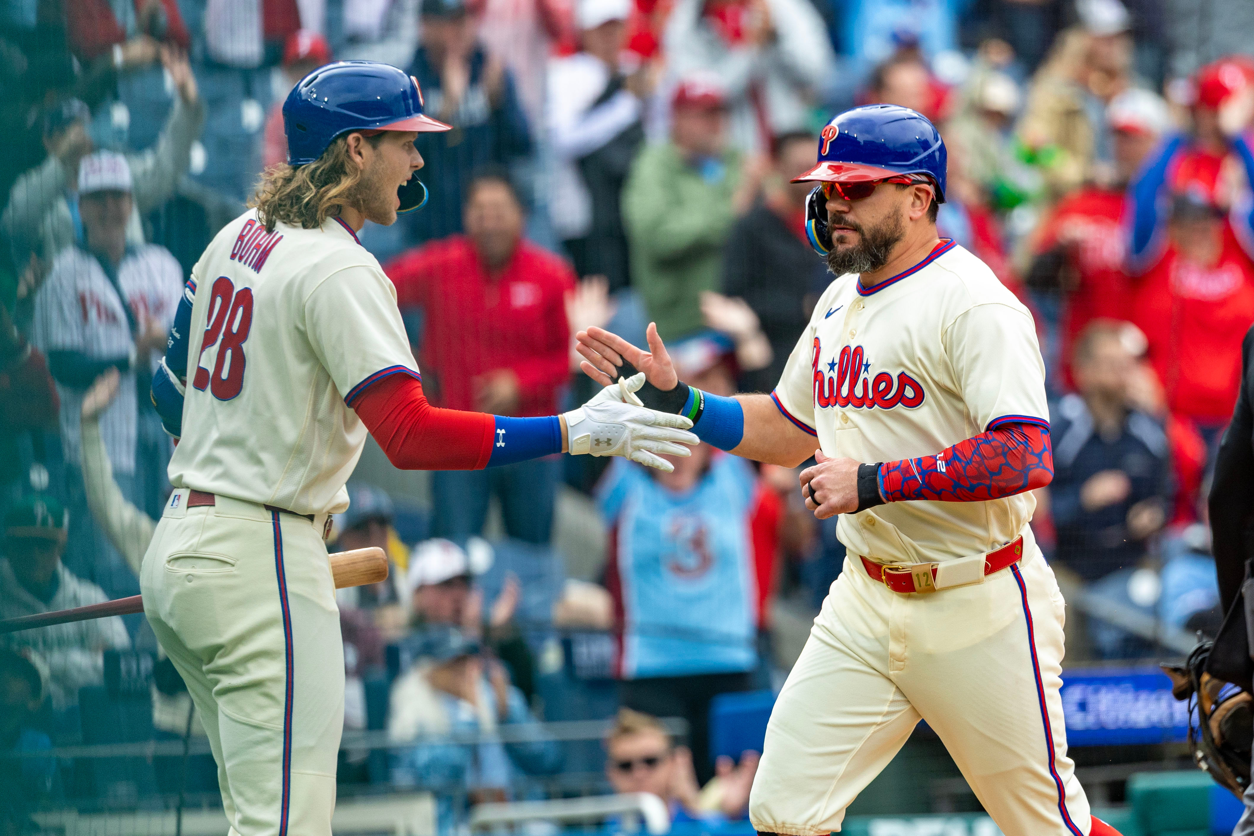 Philadelphia Phillies designated hitter Kyle Schwarber, right, is cheered by Alec Bohm, left, after scoring on an RBI double by Bryson Stott during the first inning of a baseball game against the Tampa Bay Rays, Sunday, Sept. 27, 2026, in Philadelphia. 