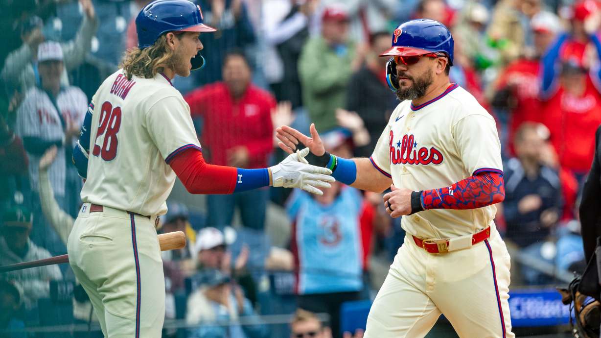 Philadelphia Phillies designated hitter Kyle Schwarber, right, is cheered by Alec Bohm, left, after scoring on an RBI double by Bryson Stott during the first inning of a baseball game against the Tampa Bay Rays, Sunday, Sept. 27, 2026, in Philadelphia.