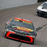 Kyle Larson passes Chase Briscoe with 7 laps left to win for the fourth time at Kansas Speedway