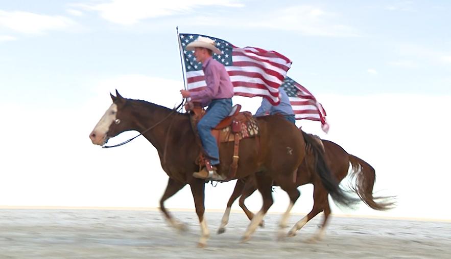 Riders carry flags across the Bonneville Salt Flats.